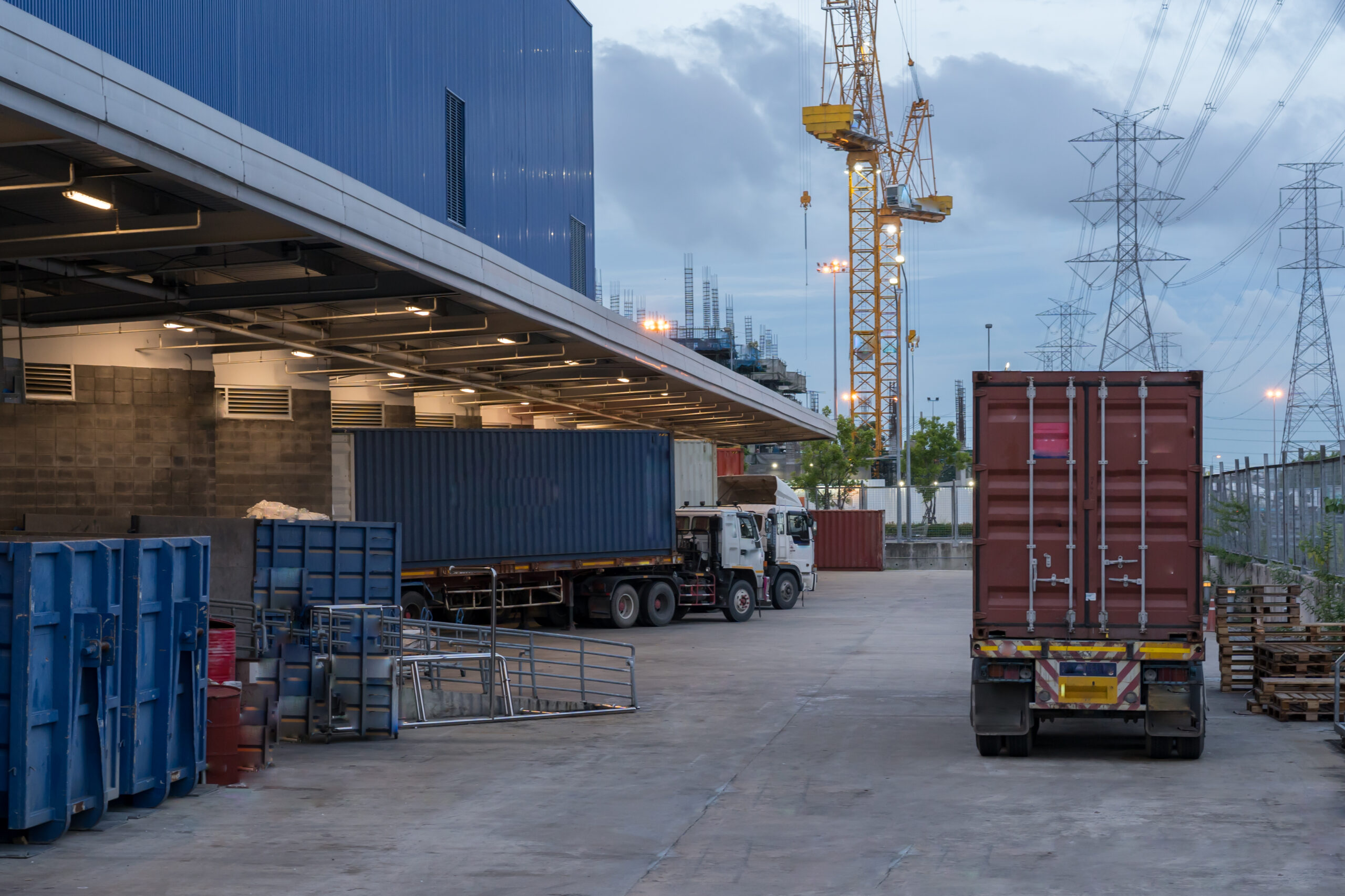 Truck is carrying container parking in front warehouse
